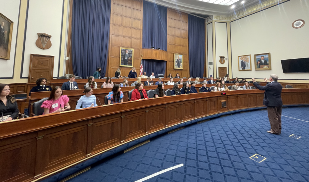 Group of people looking at a teacher sitting down