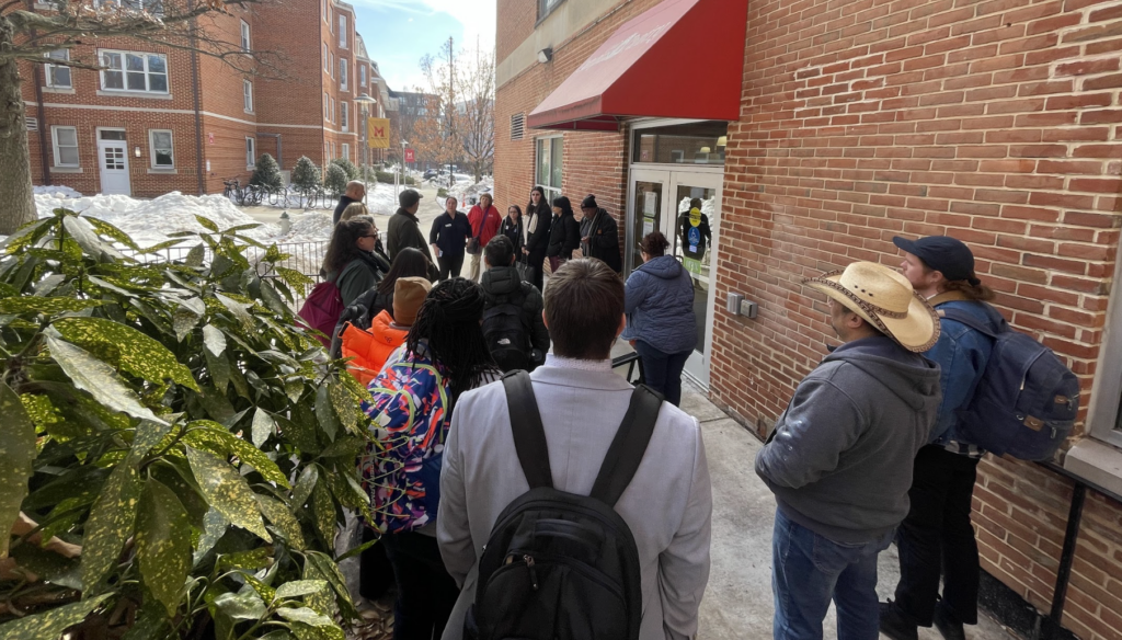 People standing outside a door 