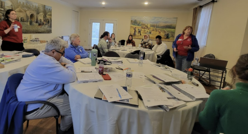People sitting at a round table with papers on the table